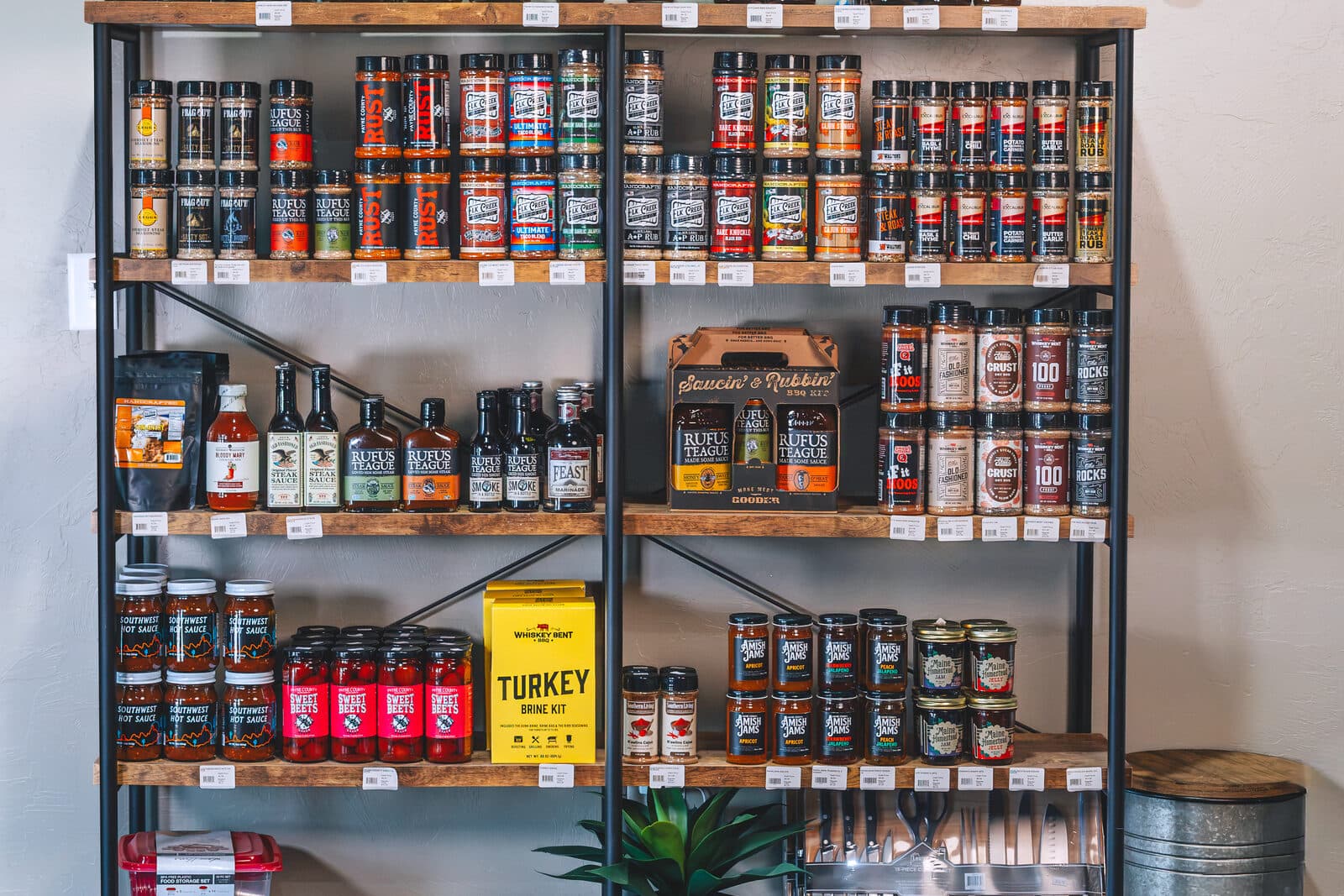 Shelf of barbecue sauces, rubs, and hot sauce