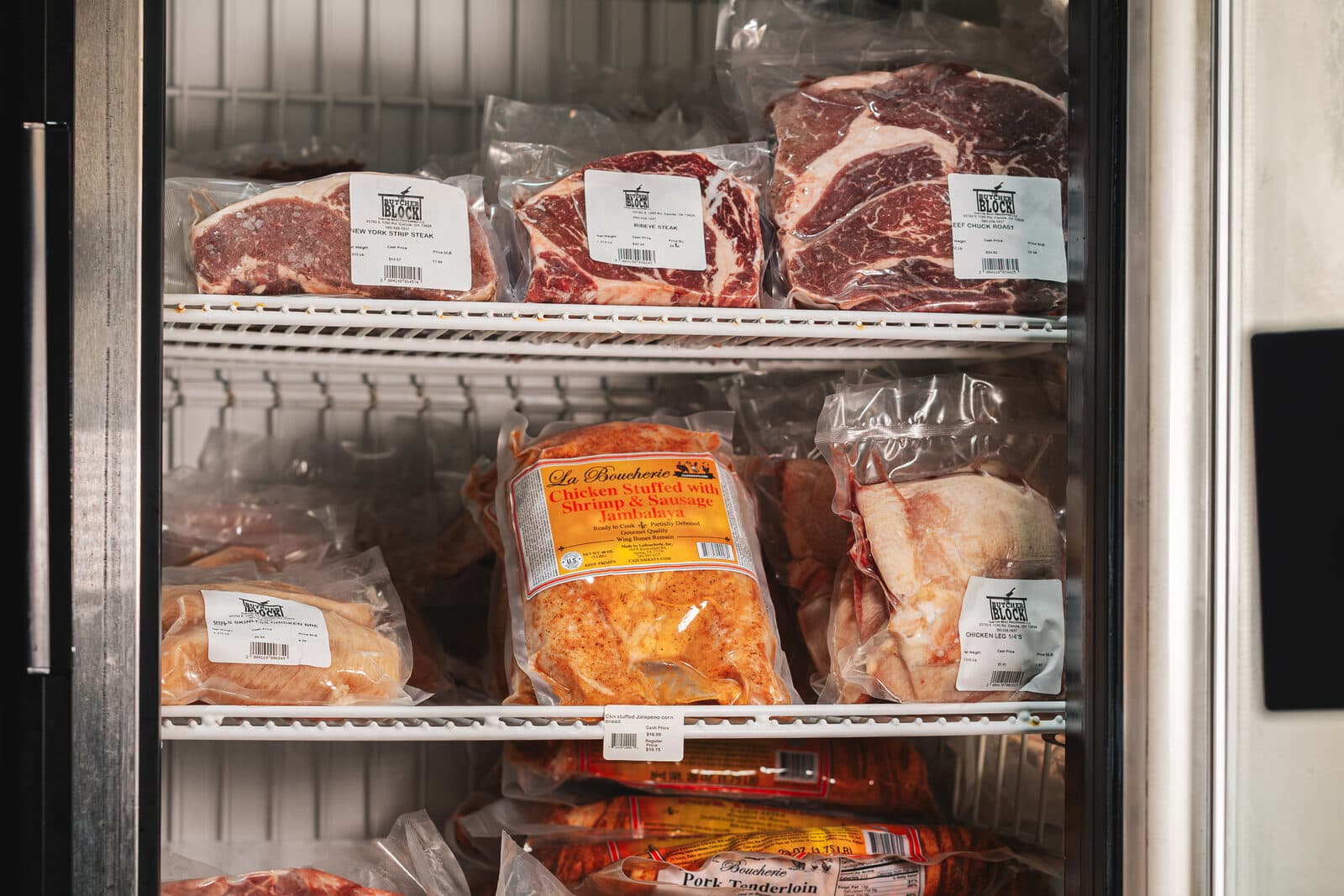 Vacuum-packed ribeyes and roasts in the retail freezer case